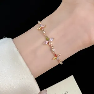 Close-up of vintage gold clover bracelet with colorful marquise-cut zircon stones