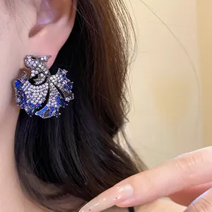 Close-up of elegant sparkling zirconia carp fish stud earring worn on ear for women