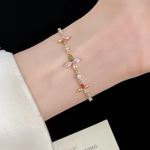 Detail of gold adjustable bracelet with colorful marquise zircon clover flowers