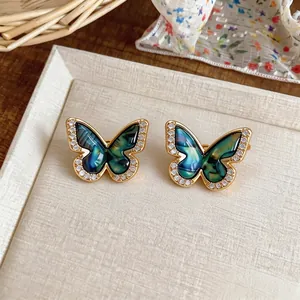 18k gold plated butterfly stud earrings with sparkling zircons and peacock blue wings.