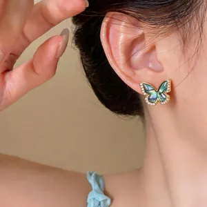 Elegant vintage 18k gold plated butterfly stud earrings with zircon crystals on ear