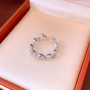 Elegant silver twisted ring with sparkling zircon stones in a luxury jewelry box
