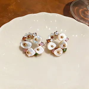 Macro view of French retro flower earrings with pearls and colored stones