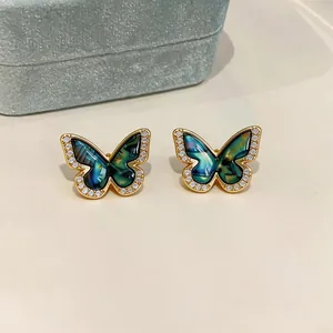 Detailed view of gold-plated butterfly stud earrings with zircon and marble resin