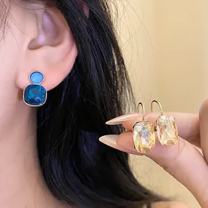 Close-up view of elegant blue and champagne square crystal drop earrings for women