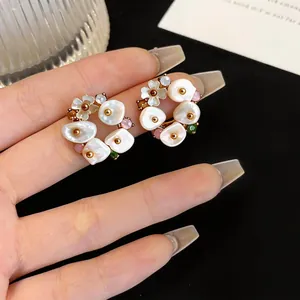 Detailed macro view of French retro flower pearl earrings featuring colorful rhinestone accents