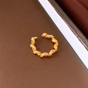 Detailed view of elegant gold twisted ring with sparkling cubic zirconia stones