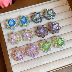 Colorful dopamine glass flower stud earrings displayed in a luxury jewelry box