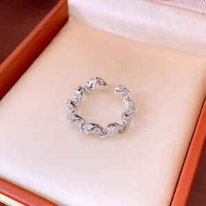 Close-up detail of a silver twisted ring with sparkling cubic zirconia in a box