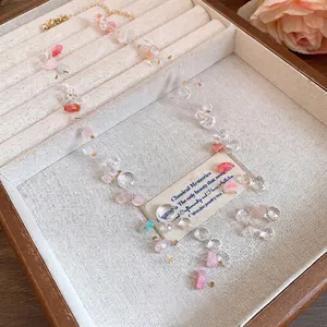 Multilayer pink and clear acrylic beaded necklace presented in a vintage wooden jewelry box