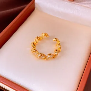 Close-up of elegant gold twisted ring with sparkling zircon stones in a gift box