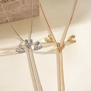 Close-up of wrinkled metallic heart pendants on adjustable gold and silver necklaces