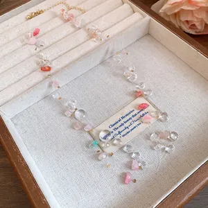 Close-up detail of layered acrylic beaded necklace displayed in a vintage jewelry box