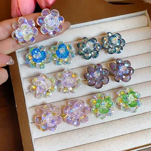 Variety of sparkling faceted glass flower stud earrings displayed in a jewelry tray