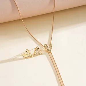 Detailed view of the hammered gold heart necklace and matching heart stud earrings set