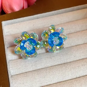 Macro view of exquisite blue glass flower stud earrings in jewelry tray