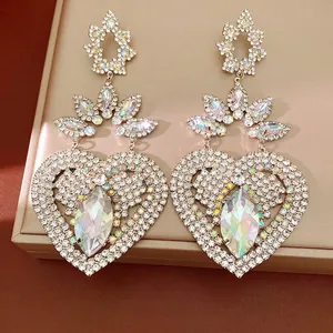 Glamorous heart-shaped earrings encrusted with iridescent rhinestones and large gems
