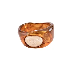 Chunky tortoiseshell resin bangle bracelet with pearlescent rose flower relief detail