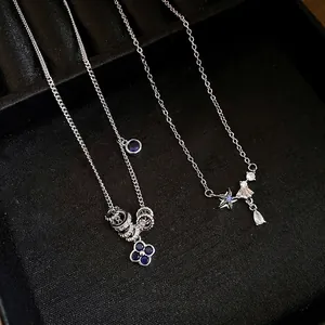 Elegant zircon flower and star pendant necklace set displayed on a black jewelry tray