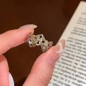 Detailed close-up of a vintage style golden bow knot ring with zircon stone accents.