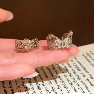 Detailed view of vintage bow-knot and filigree open rings with sparkling zircons