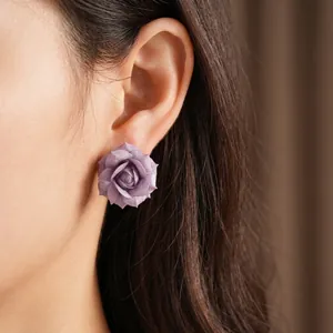 Elegant purple rose flower stud earrings with 18K gold plating worn on an Asian model.