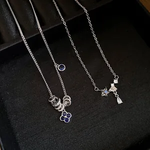 Detailed shot of elegant silver necklaces with blue zircon clover and starfish pendants