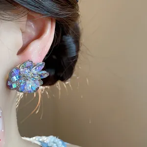 Macro detail of an iridescent glass flower stud earring with holographic petals