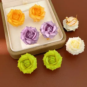 Detail view of multi-color 18K gold plated rose stud earrings in a jewelry box