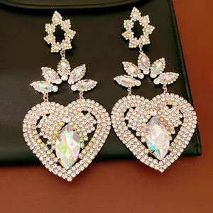 Close-up detail of luxurious vintage heart-shaped dangle earrings with AB crystal accents