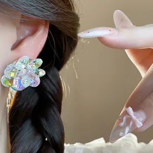 Close-up detail of colorful glass flower earrings with iridescent crystal petals