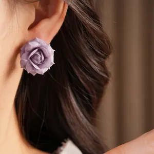 Close-up of elegant purple rose flower stud earrings with 18K gold plating and silver needles
