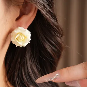 Elegant white rose flower stud earring featured in a close-up model detail shot