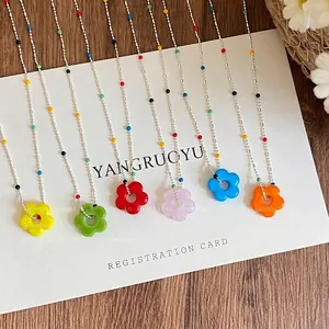 Macro view of colorful resin flower necklaces in various vibrant rainbow shades