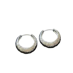 Stylish silver-colored textured hoop earrings with minimalist circular design