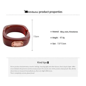 Detail view of square resin bangle with peach rhinestone and product specifications