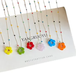 Vibrant dopamine flower beaded necklaces with colorful pendants on white display card