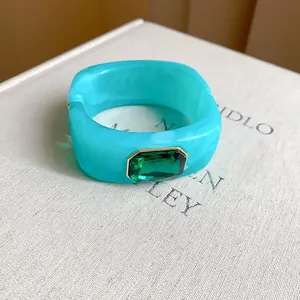 Detail shot of turquoise resin square bracelet with emerald green gemstone embellishment