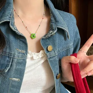 Exquisite colorful dopamine floral beaded necklace with a green flower pendant on model