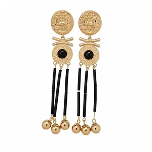 Vintage gold tassel earrings featuring portrait relief and black Greek key details