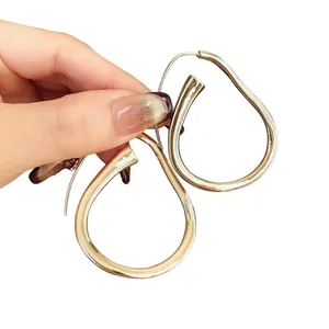 Grandi orecchini a cerchio a goccia dorati dal design minimalista elegante