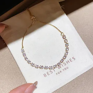 Detail view of sparkly marquise-cut cubic zirconia stones on a gold slider bracelet