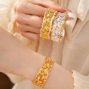 Close-up detail of French retro lace-edge hollow gold and silver bangles with crystals
