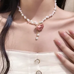 Elegant pink rose flower pendant with pearl beads necklace displayed on model's neck