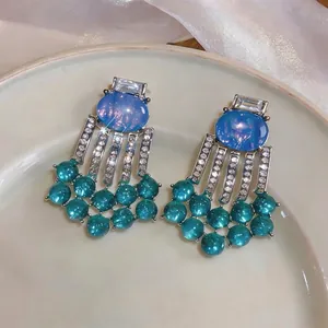Elegant vintage palace style earrings with oval blue resin and teal bead fringe