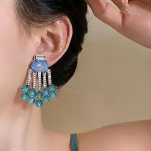 Vintage palace style tassel earrings featuring oval resin and sparkling crystals