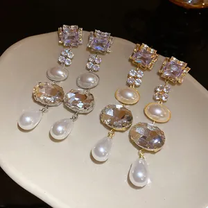 Detailed view of luxury silver and gold tassel earrings with pearls and crystals.