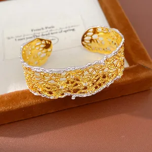 Close-up view of a gold and silver lace openwork cuff bracelet in retro French style