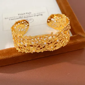 Macro detail of French retro hollow lace gold cuff bracelet with clear rhinestones