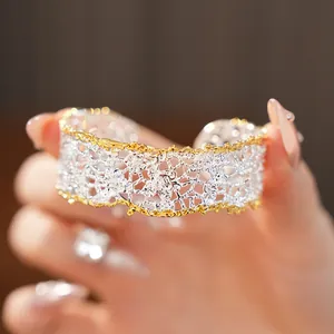 Detail of French vintage lace-pattern hollow bangle with silver and gold two-tone finish